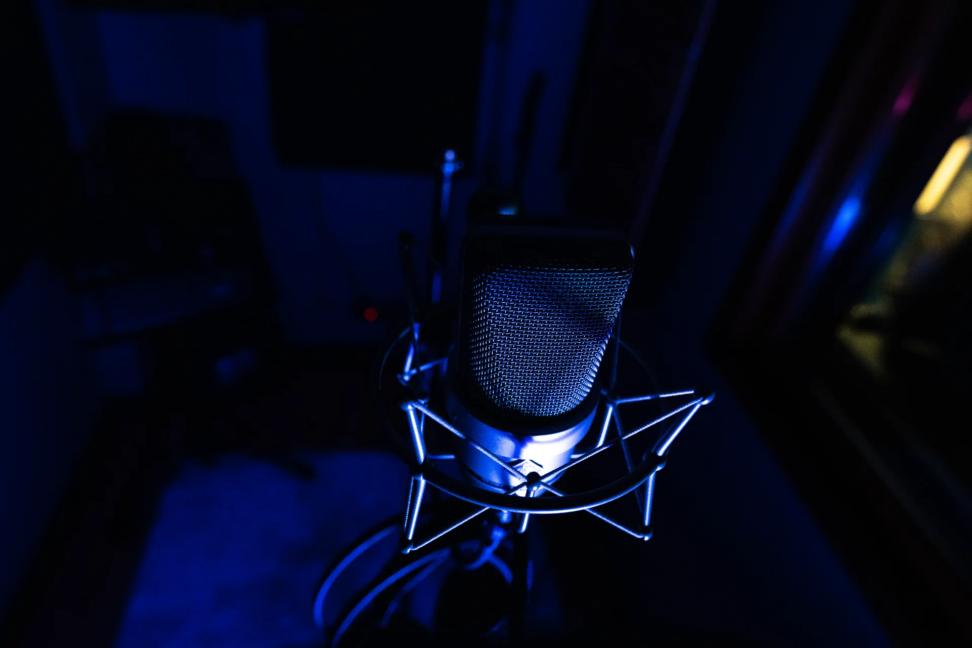 Close view of a studio microphone under blue light